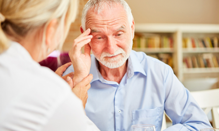 senior citizen speaks with doctor
