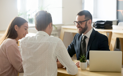 smiling bank worker speaks to couple