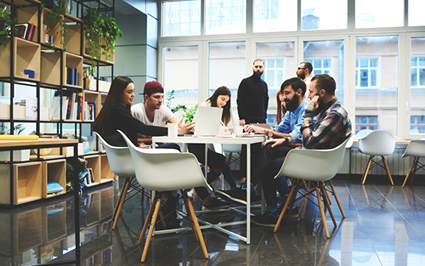 young people startup company sit around a table in an office